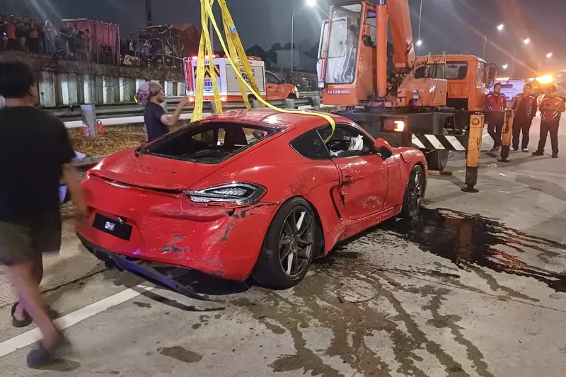 Sopir Hilang Kendali, Porsche Merah Nyungsep ke Saluran Air di Tol Desari